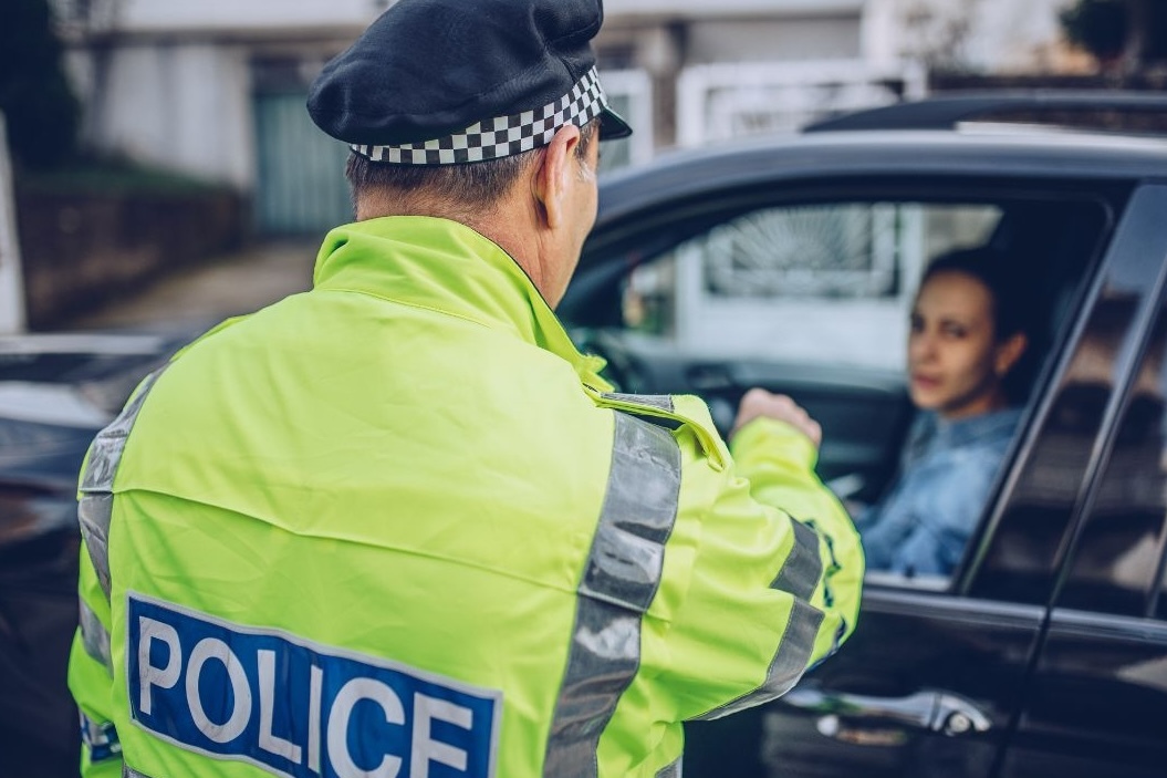 police officer and woman in car